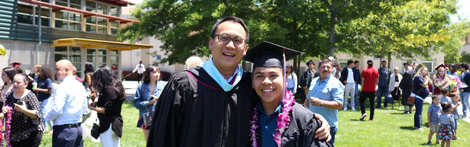 students on marchingto graduation in caps and gowns