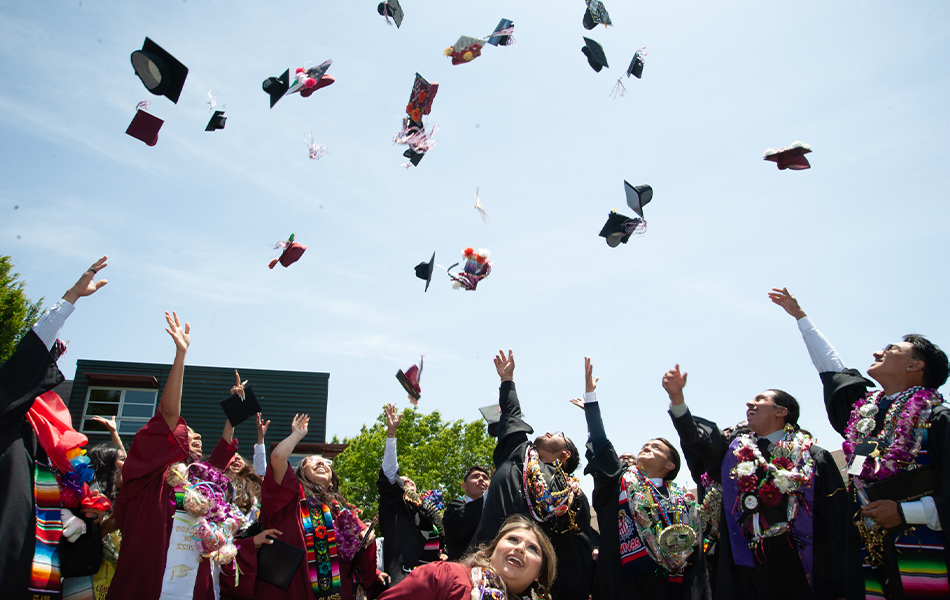 Students tossing caps into the air at graduation
