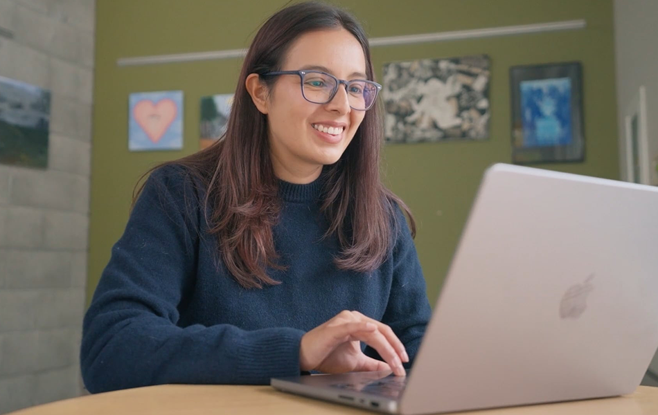 Eastside alum Vanessa works on a laptop